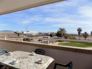 a table and chairs on a balcony with a view at Playa R84MED010 in La Estación