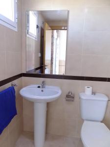 a bathroom with a sink and a toilet and a mirror at Playa R84MED010 in La Estación