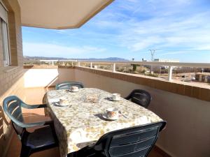 a table and chairs on a balcony with a view at Playa R84MED010 in La Estación