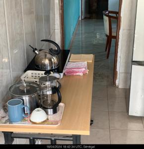 a stove with pots and pans on a table at Studio Salam in Ziguinchor