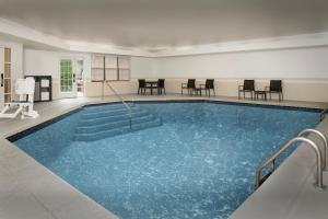 a large swimming pool with blue water in a room at Residence Inn Kansas City Overland Park in Overland Park