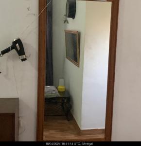 a hallway with a mirror and a table in a room at Studio Salam in Ziguinchor