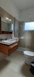 a bathroom with a sink and a toilet and a shower at Christos in Kissamos +20 photos