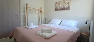 a bedroom with a bed with two towels on it at Christos in Kissamos