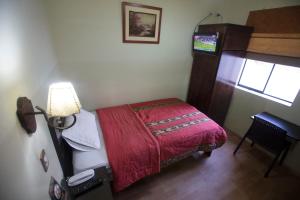 Postel nebo postele na pokoji v ubytování Hotel Tinkus Inn