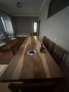 a long wooden table in a room with chairs at Zaritap Guest House in Zarritʼapʼ