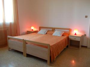 a bedroom with a large bed with two night stands at Travellers Lodge Bed & Rooms in Treviso