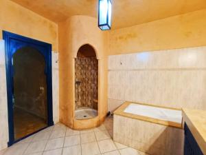 a bathroom with a bath tub and a shower at Villa Beautiful Dreams in Oualidia