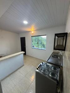 an empty kitchen with a stove in a room at Casa Bela Vista in Angra dos Reis