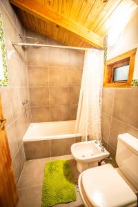 ein Badezimmer mit einem Waschbecken, einem WC und einer Badewanne in der Unterkunft Casa en entorno de bosque, cerca de playas y cerros in San Carlos de Bariloche