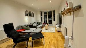 a living room with a couch and a table and chairs at Entire Apartment in London in Bromley