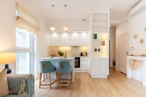a kitchen with white cabinets and a kitchen island at FoRest Longinówka - las, jezioro, parking, Netflix i Prime, TV55" in Brodnica +31 photos