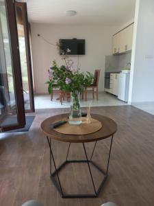 a vase of flowers on a table in a living room at Drinsko Srce 2 in Ljubovija +20 photos