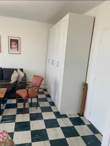 a living room with a couch and a chair at Appartement agréable Cosne- Cours- sur- Loire in Cosne-Cours-sur-Loire +3 photos
