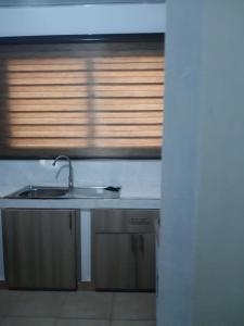 a kitchen counter with a sink and a window at The Alpha* residence in Tema