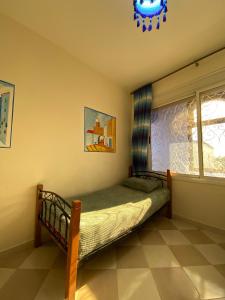 a bedroom with a bed and a window at House blue pearl chefchaouen in Chefchaouen
