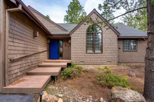 a house with a blue door and stairs at Welcome to the Kinglet's Nest, Spacious property with AC SHARC, Hot-tub, Bikes, Games, Grill, Golf and Pets in Sunriver