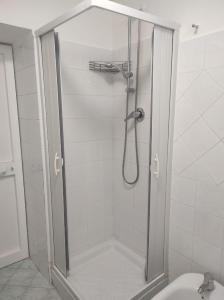 a shower with a glass door in a bathroom at SUITE HOME VIA ROMA in SantʼAntonio Abate