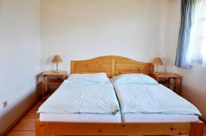 a bedroom with a bed with two pillows at Chata 115 Tatralandia in Liptovský Mikuláš