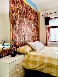 a bedroom with a bed and a mosaic wall at semi-detach in Saint Helens