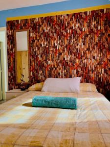 a bedroom with a large bed with a mosaic wall at semi-detach in Saint Helens