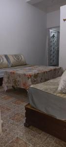 two beds sitting next to each other in a room at Perle in Aïn El Turk