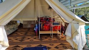 a room with a tent with a bed in it at Linga Longa Spiritual Retreat in Curra