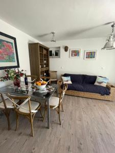 a living room with a table and a couch at Libra in Okrug Gornji +12 photos