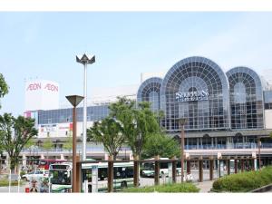 a large building with a bus station in front of it at La Mer Urayasu - Vacation STAY 11148 in Urayasu
