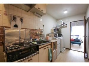 a kitchen with a stove and a sink in it at Maison Cresta Urayasu - Vacation STAY 11150 in Urayasu
