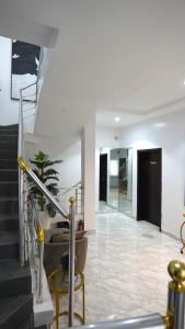 a lobby with a staircase and a stair case at SHORTLETMART Apartments in Lekki
