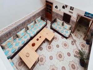 an overhead view of a living room with a table and chairs at Medina Oasis Hostel in Marrakesh