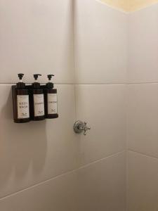 three bottles of soap on a shelf in a bathroom at Point Bay Resort in Calliaqua