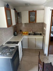 a kitchen with a stove and a sink at Apartments with a parking space Murvica, Brac - 22780 in Bol