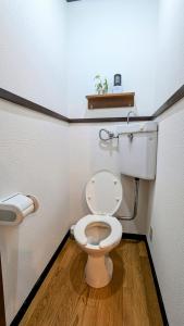a bathroom with a white toilet and a wooden floor at Animal Art Apartment 201 in Ogikubo +16 photos