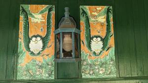 a lamp on a green door with owls on it at Animal Art Apartment 201 in Ogikubo