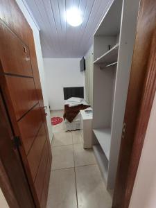 a small room with a door and a room with a closet at Pousada Pontal da Armação in Penha