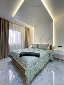 a bedroom with a large bed with a large wall at TANGIER DUPLEX LUXURY apartment GUEST FRIENDLY B4 in Tangier