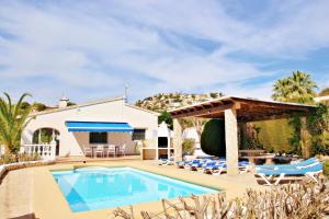 a villa with a swimming pool and a gazebo at Kathrin - beautiful little house in pretty grounds with lovely views in Benissa in Benissa