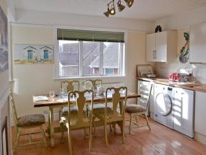 a kitchen with a table and chairs and a dining room at Bayview in Overcombe