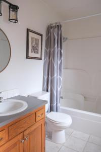 a bathroom with a toilet and a sink and a tub at The Landmark Inn on Orcas Island in Eastsound
