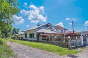 a house with a fence in front of it at The Jeffy Pool Villa in Chanthaburi