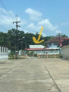 an empty parking lot with a large yellow symbol at The Jeffy Pool Villa in Chanthaburi