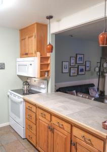 a kitchen with wooden cabinets and a white stove top oven at The Landmark Inn on Orcas Island in Eastsound