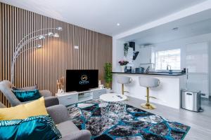 Stunning 3 br house near Leeds City Centre with Free Parking في Hunslet: غرفة معيشة مع أريكة وتلفزيون