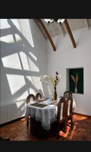 a dining room with a table with chairs and a shadow at Contando Historia in Potosí