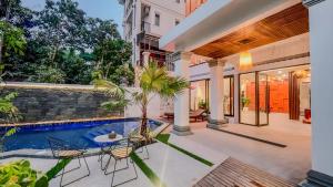 an exterior view of a house with a swimming pool at The Luxury in Siem Reap