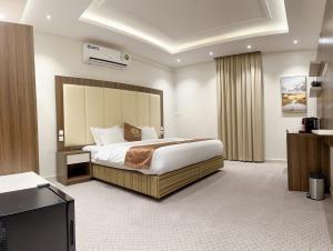 a hotel room with a bed and a television at فندق النزيل الذهبي - Golden Guest Hotel in Jazan