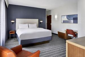 a hotel room with a bed and a desk at Courtyard by Marriott Nashville Downtown in Nashville