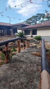 a building with a bunch of logs in front of it at Windmill Chimes in Rizal